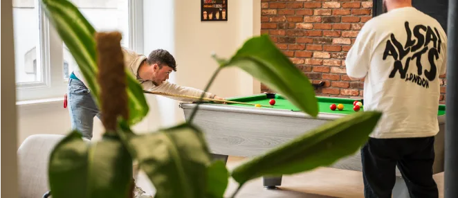 Some of our employees playing a game of pool in the communal area