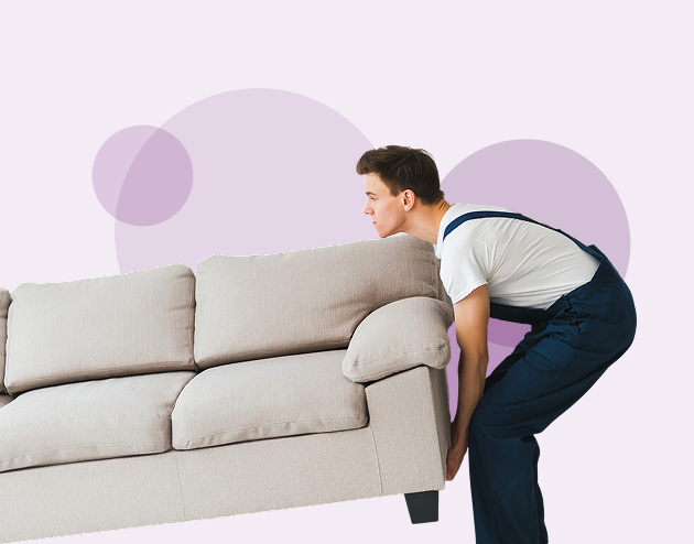 Removal worker lifting a sofa.
